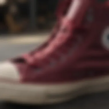 Close-up of burgundy high top Converse showcasing design details