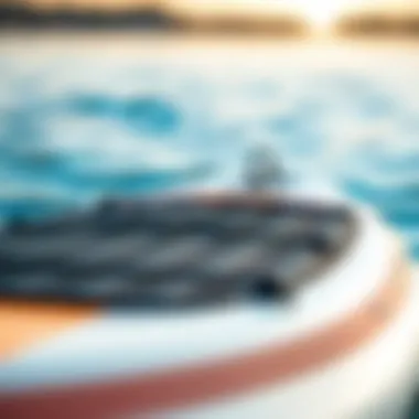 Close-up view of a well-maintained used inflatable paddle board in a serene water setting