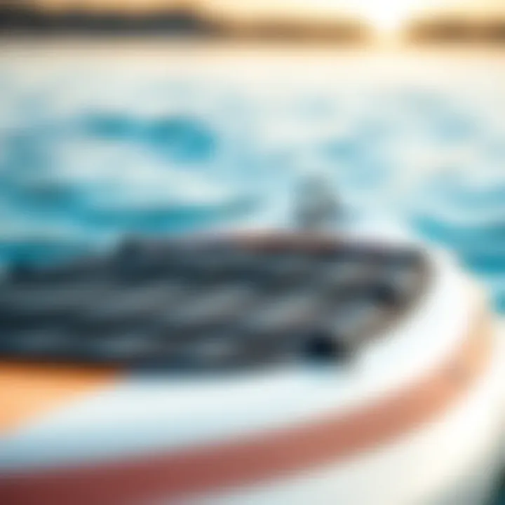 Close-up view of a well-maintained used inflatable paddle board in a serene water setting