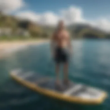 An eFoil board ready for rental with the lush Maui coastline in the background.