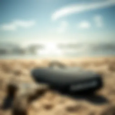 Close-up of Dakine surf accessories laid out on a sandy beach