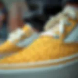 Intricate Design of Gold Vans Slip-Ons Close-up view of gold Vans slip-ons showcasing intricate design and texture