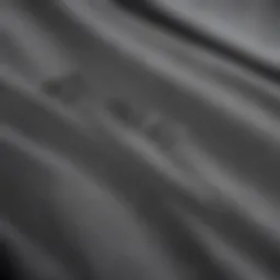 Close-up view of the fabric texture of grey Nike tracksuit pants
