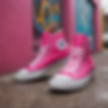 Artistic display of hot pink Converse shoes against a graffiti backdrop