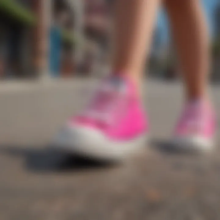 Vibrant hot pink Converse shoes on a skateboard