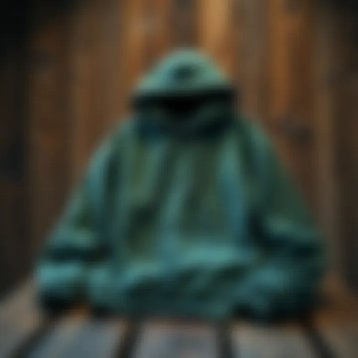 Stylish pine green hoodie displayed on a rustic wooden table