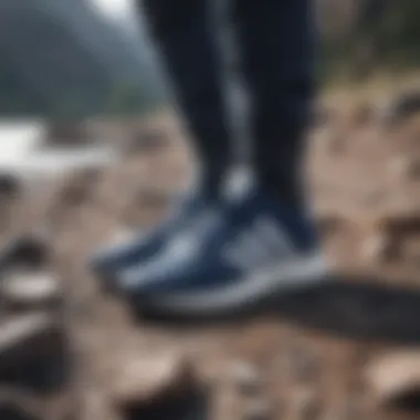 Stylish navy and white Adidas footwear on a rocky terrain