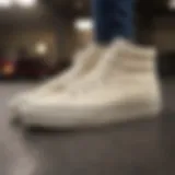 Stylish cream hi-top Vans on a skateboard