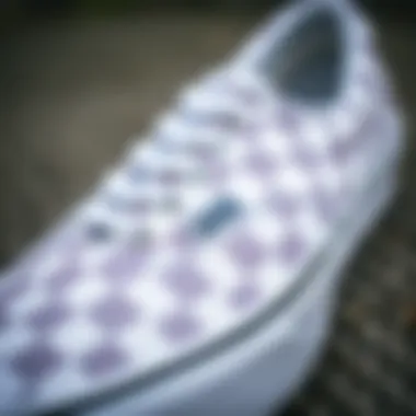 A close-up of white checkerboard Vans detailing