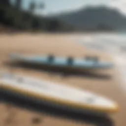 Different sizes of paddle boards displayed on a beach