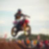 A skilled rider executing a jump during a motor cross event.