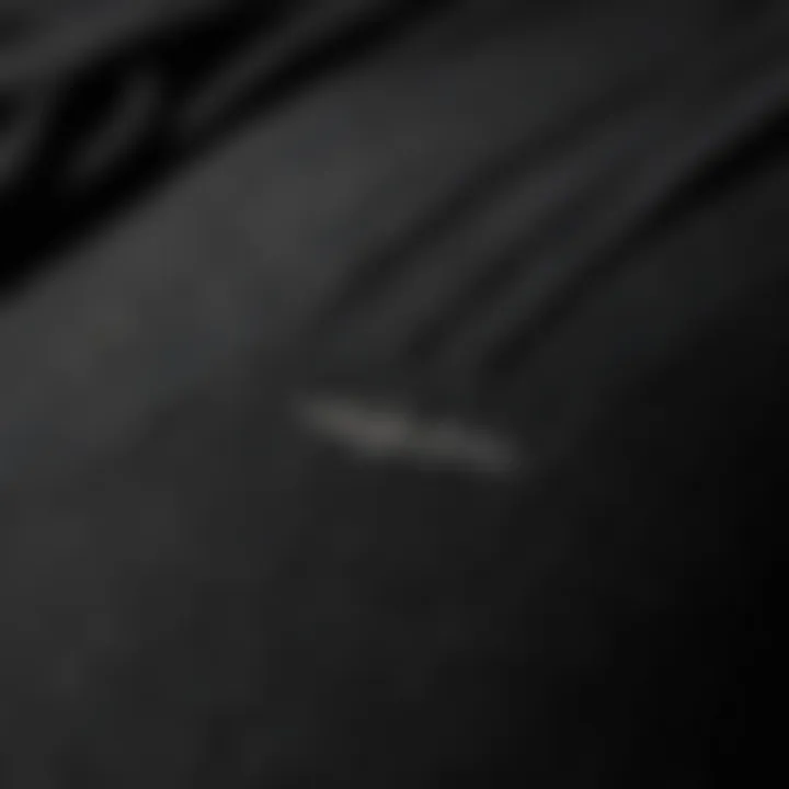 Close-up of the fabric texture of all black Adidas pants highlighting quality.