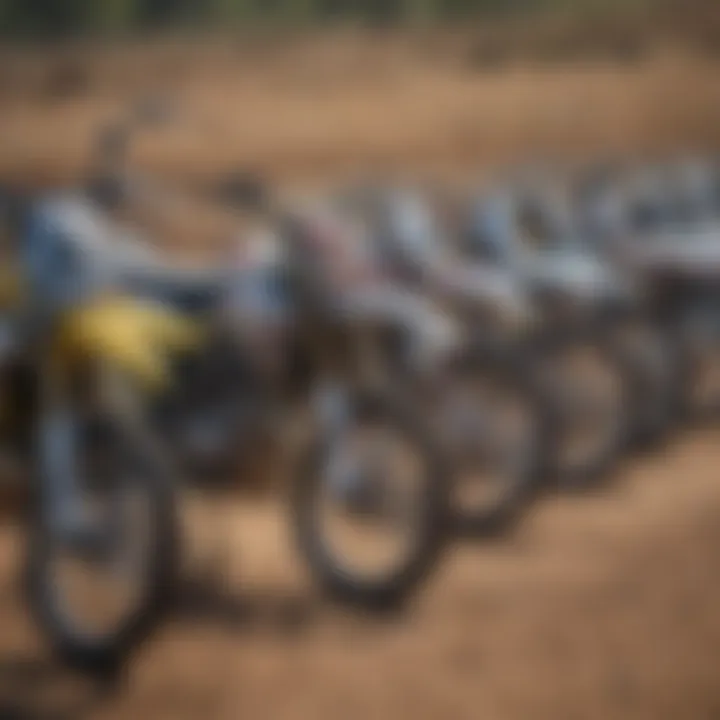 An array of motocross bikes lined up in a paddock, showcasing their technical designs.