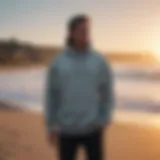 A stylish surf changing hoodie displayed on a sandy beach