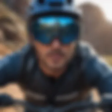 A mountain biker wearing black blue light glasses during a ride