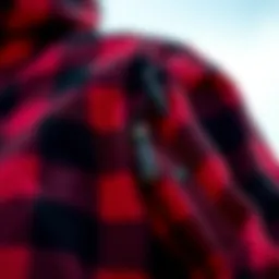 A close-up view of the texture and pattern of a red and black plaid jacket.