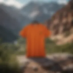 A vibrant orange pocket t-shirt displayed against a rugged outdoor backdrop.