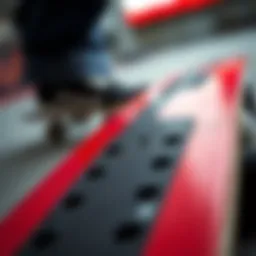 Close-up of red grip tape on skateboard deck