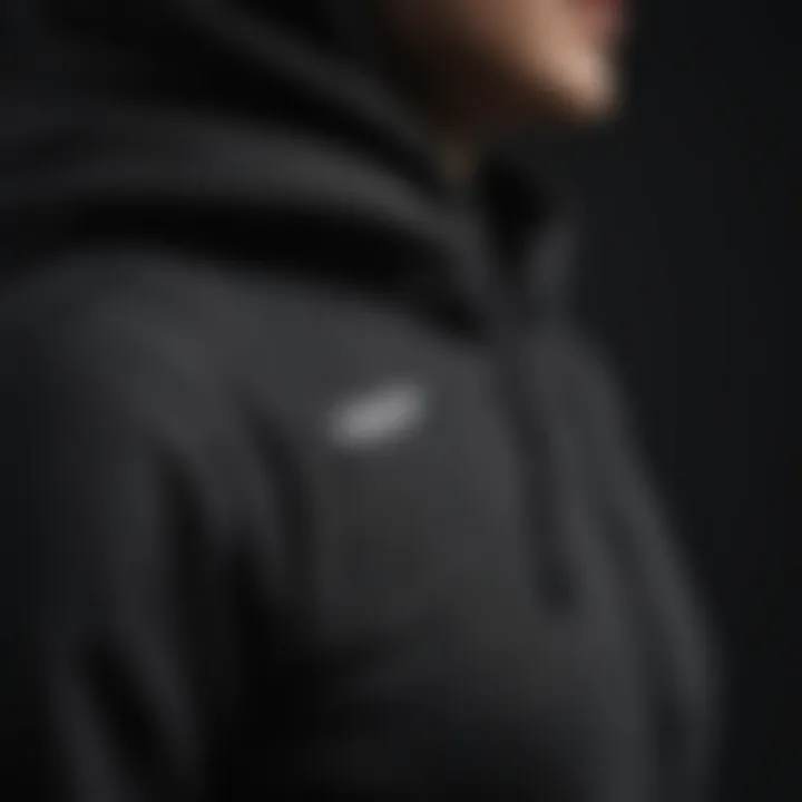 A close-up view of the fabric technology used in the black pullover hoodie.