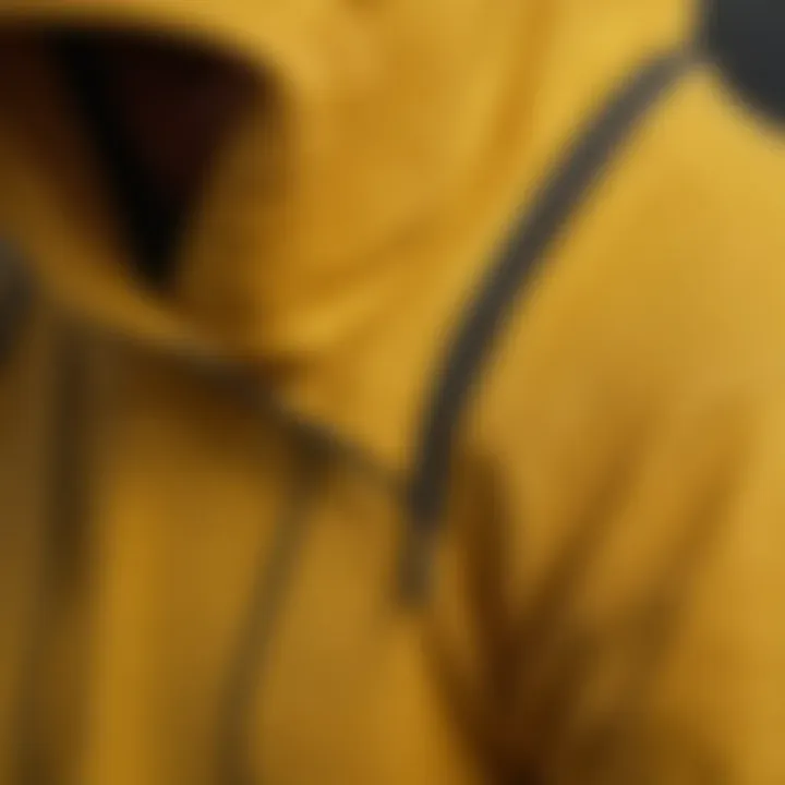 Close-up of the fabric texture and stitching details of a high-performance yellow hoodie