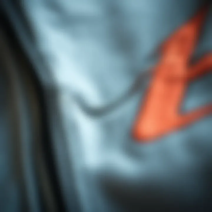 A close-up of the fabric texture of a grey graphic zip-up hoodie