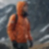 A climber wearing a windbreaker with a hood against strong winds on a mountain.